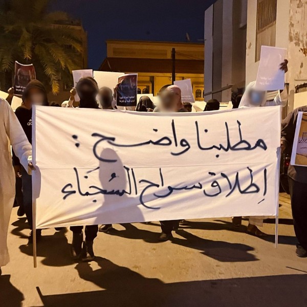 Demonstrators hold banner with slogan calling for the release of political prisoners
