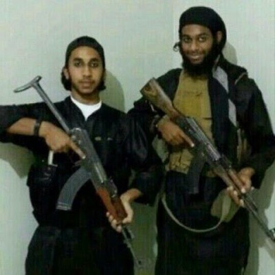 - Ali Al-Rowayi, nicknamed Abu Hamza Al-Bahraini, standing beside an Arab militant